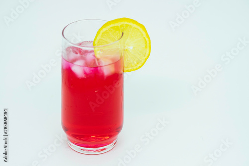 Cold strawberry drink with sicilian lemon on white background.