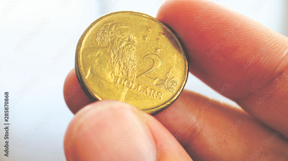Close the Holding Australian Dollars Coin on Hand and Finger Close the Holding Australian Dollars Coin on Hand and Finger