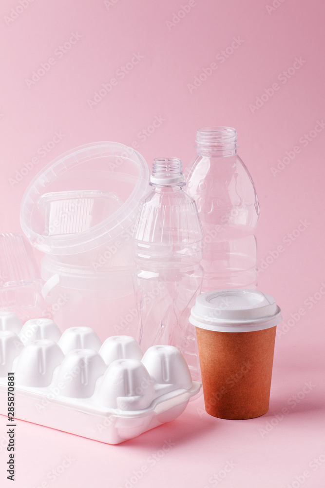 Group of transparent plastic containers box of food package on pink background. Concept of earth pollution, one time usable packaging, plastic ban Group of transparent plastic containers box of food package on pink background. Concept of earth pollution, one time usable packaging, plastic ban