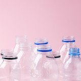 Set of empty plastic water bottles on pink background, chemical industry, eco recycle plastic material, zero waste concept, plastic ban