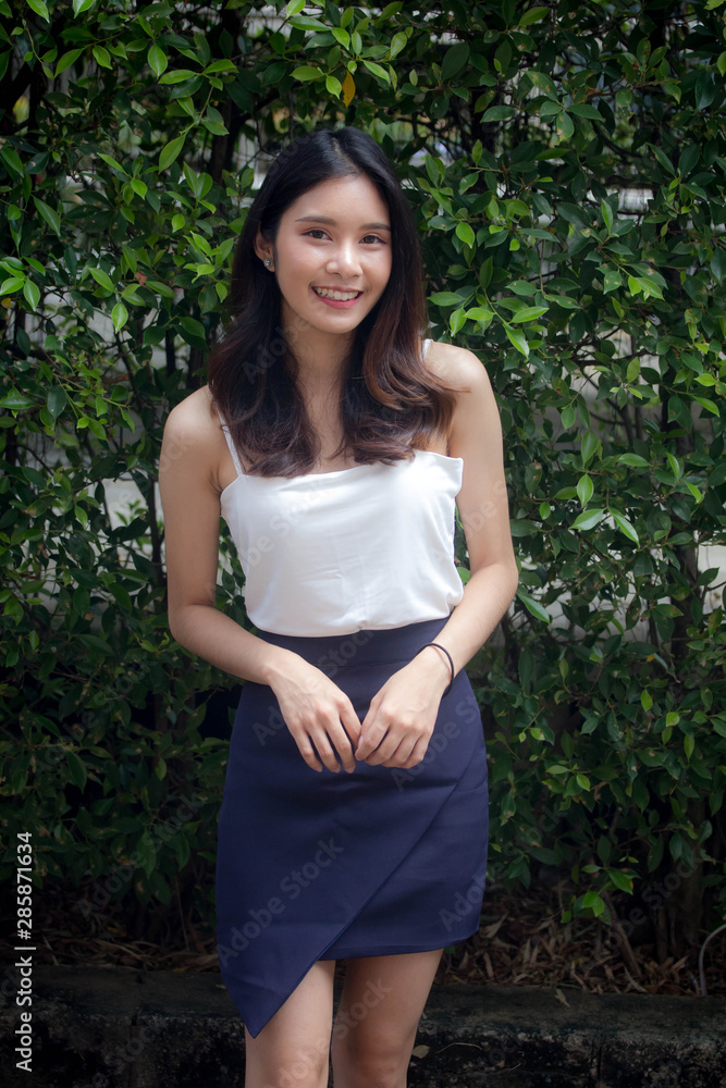 Portrait of thai china adult beautiful girl White shirt relax and smile Portrait of thai china adult beautiful girl White shirt relax and smile