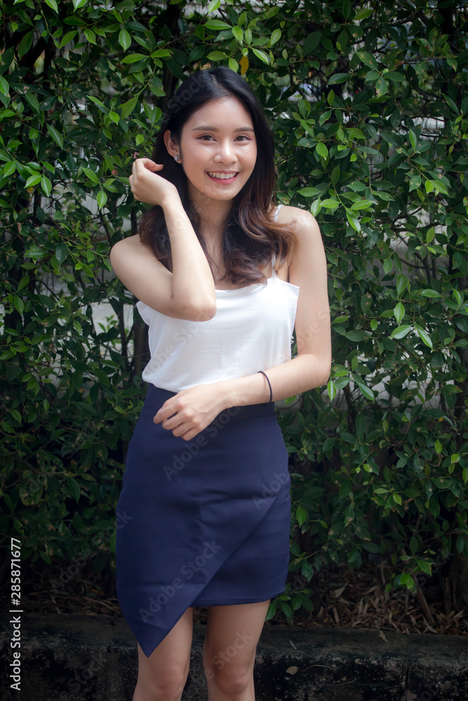 Portrait of thai china adult beautiful girl White shirt relax and smile Portrait of thai china adult beautiful girl White shirt relax and smile