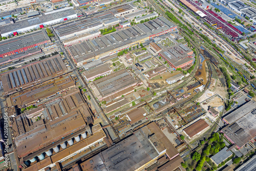 bird eye view of suburb industrial zone with lots of industrial buildings and manufacturing companies