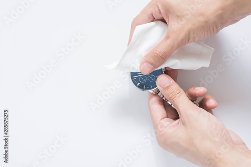 Close up cleaning modern watch with microfiber cloth and Cleaner cream concept.Cleaning modern watch by Cleaner cream.Cleaning stainless steel by Cleaner cream,Cleaning leather by Cleaner cream,