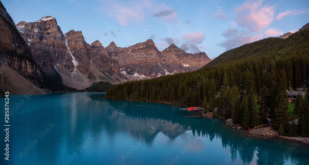 Beautiful view of an Iconic Famous Place, Moraine Lake, during a vibrant summer sunrise. Located in Banff National Park, Alberta, Canada.