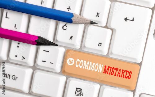 Word writing text Common Mistakes. Business photo showcasing actions that are often used interchangeably with error White pc keyboard with empty note paper above white background key copy space photo