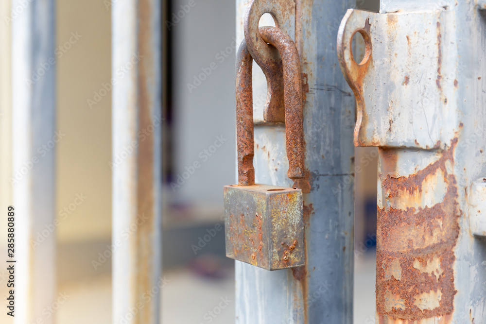 Selective focus of Old master key with rust unlocked on old aluminum fence, Security concepts Selective focus of Old master key with rust unlocked on old aluminum fence, Security concepts