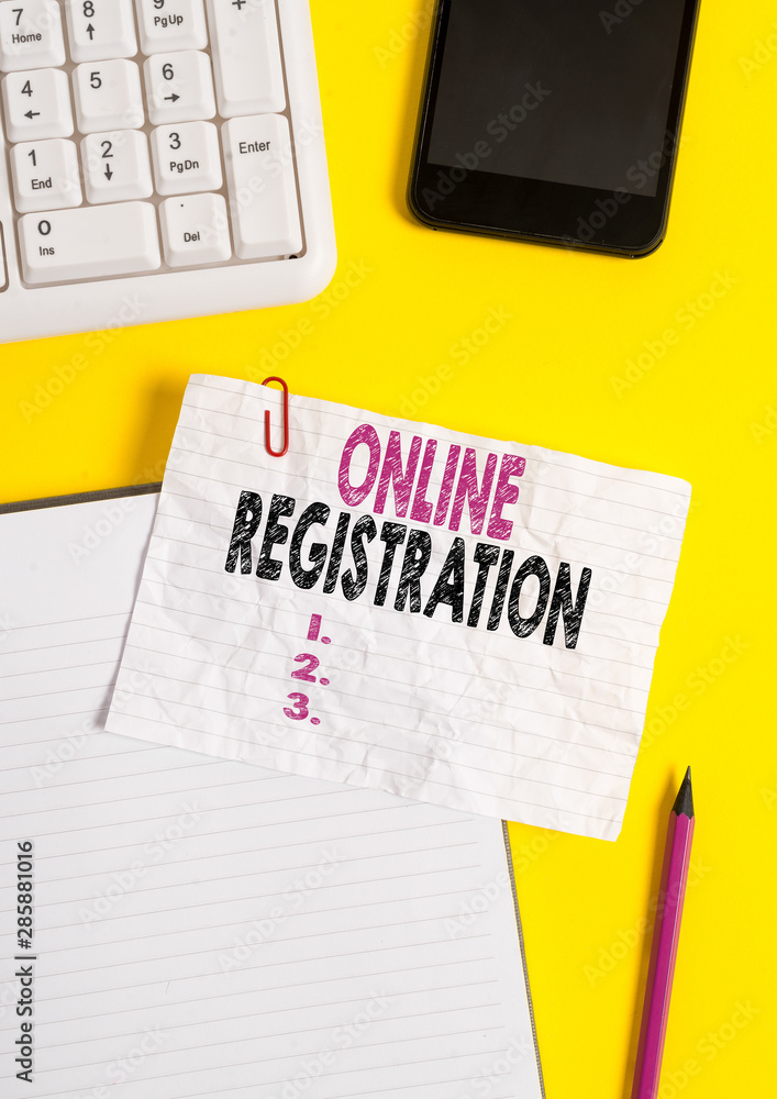 Text sign showing Online Registration. Business photo text System for subscribing or registering via the Internet Crumpled white paper on table with paper clips clock mobile and pc keyboard