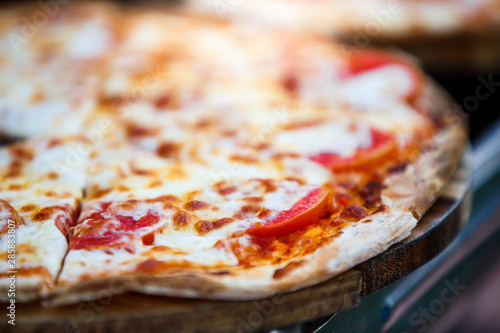 close-up pizza on wooden plate , selective focus