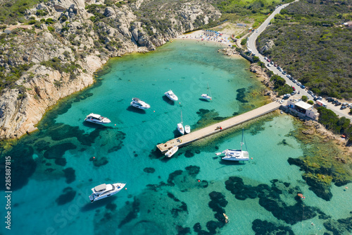 View from above, stunning aerial view of luxury yachts and boats floating on an emerald green bay of water in Sardinia. Maddalena Archipelago National Park, Sardinia, Italy...