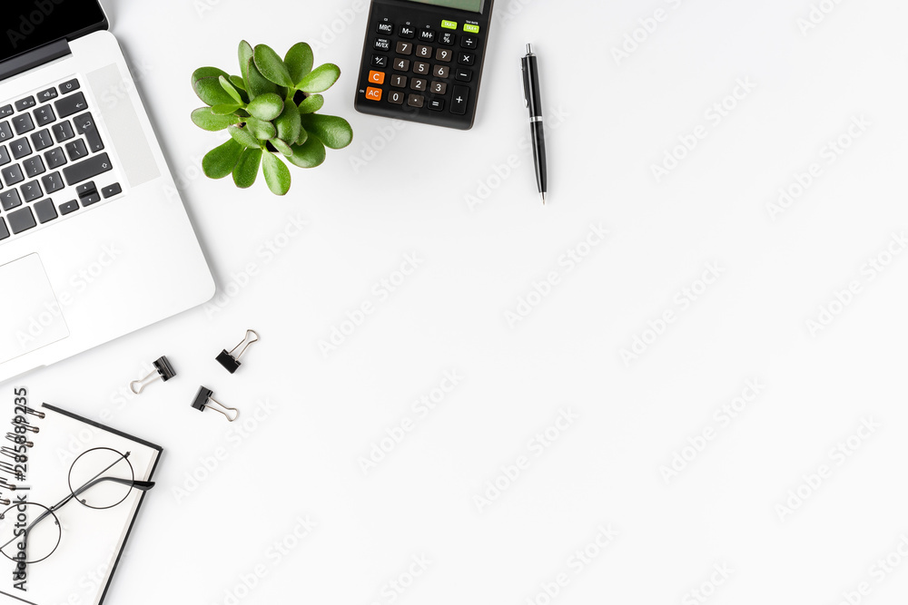 Office desktop with laptop, calculator and business accessories isolated on  white background. Business concept Stock Photo | Adobe Stock