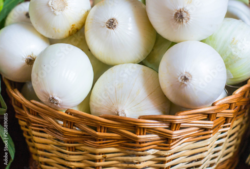 White onion in wicker basket close-up.