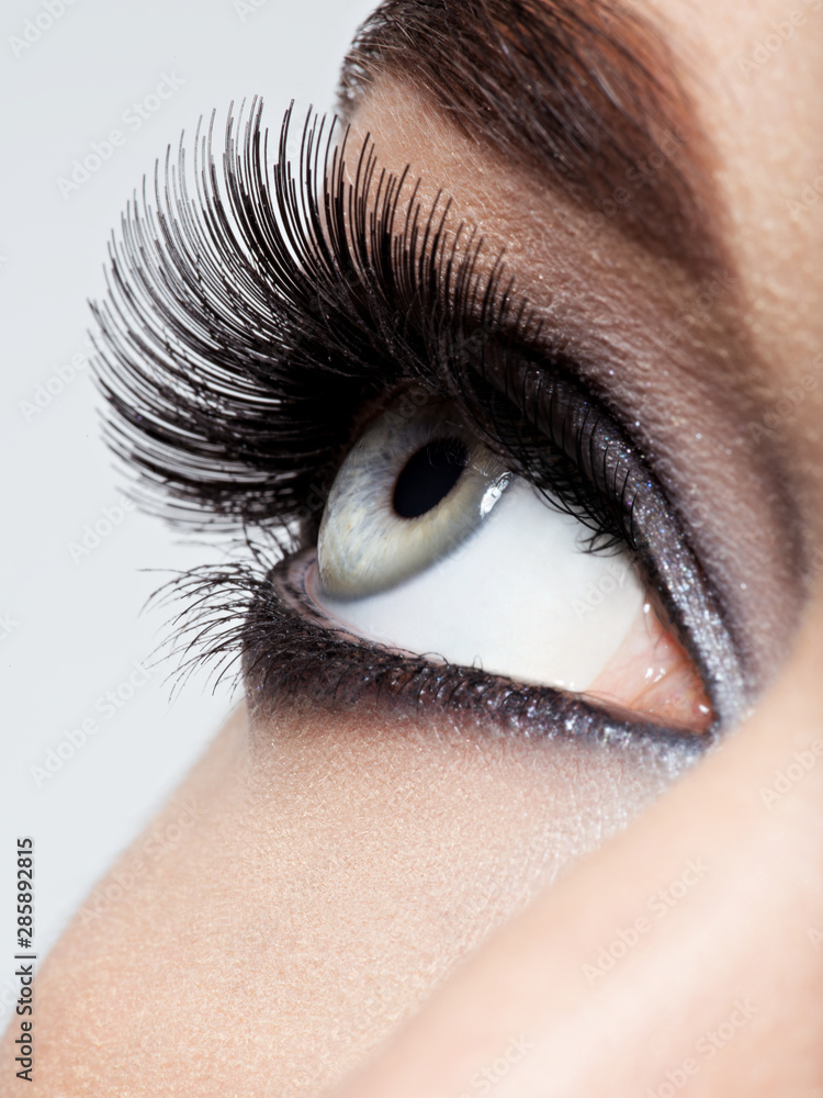 Naklejka premium woman's eye with black eye makeup. Macro style image