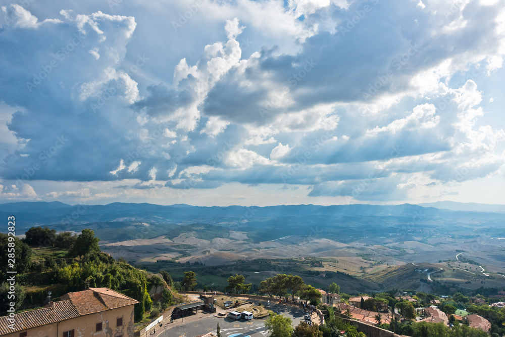 Cityscape over the roofs and surrounding landscape, a view from bell tower at Piazza dei Priori in Volterra, Tuscany, Italy