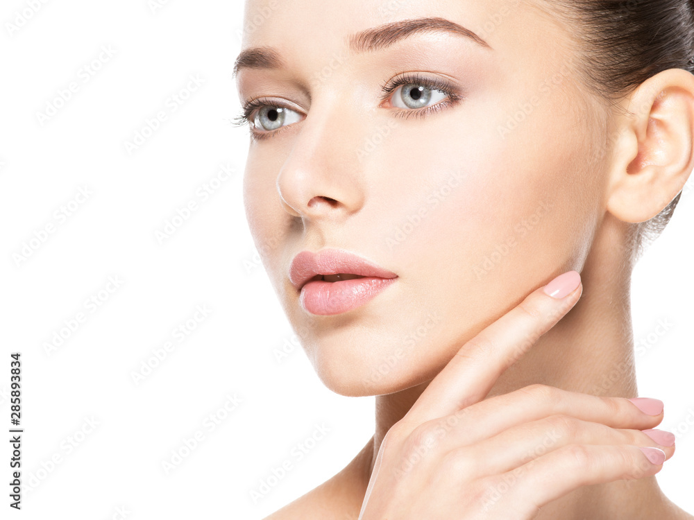Young woman with healthy clean skin touches the face. Skin care concept. Young woman with healthy clean skin touches the face. Skin care concept.