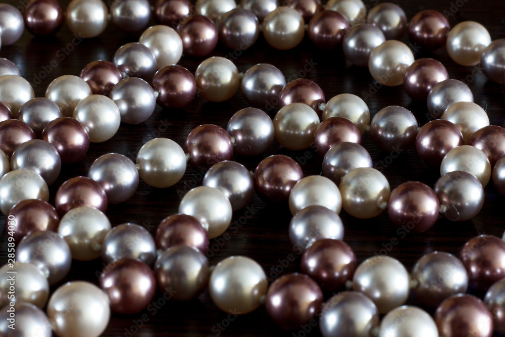 Beads of pearls on a black background closeup Beads of pearls on a black background closeup