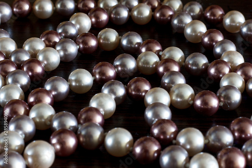 Beads of pearls on a black background closeup
