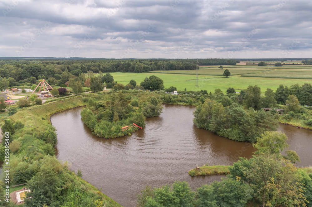 Fototapeta premium Amusement park with various attractions. Top view on the lake with boats
