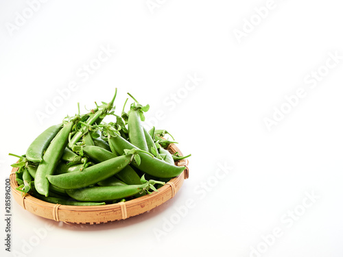 green pea pod In a bamboo container