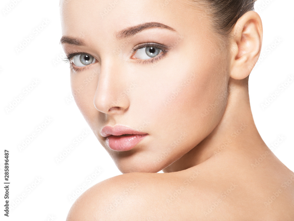 Beautiful face of young woman with healthy clean skin