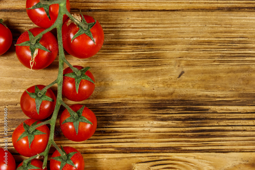 Fresh cherry tomatoes on a wooden table. Top view Fresh cherry tomatoes on a wooden table. Top view