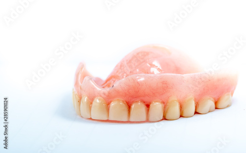 Old denture on a white background.