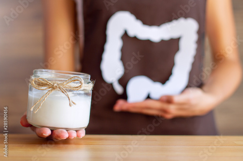 Fotografía Female hand is holding jar with natural organic yogurt with bifidobacteria