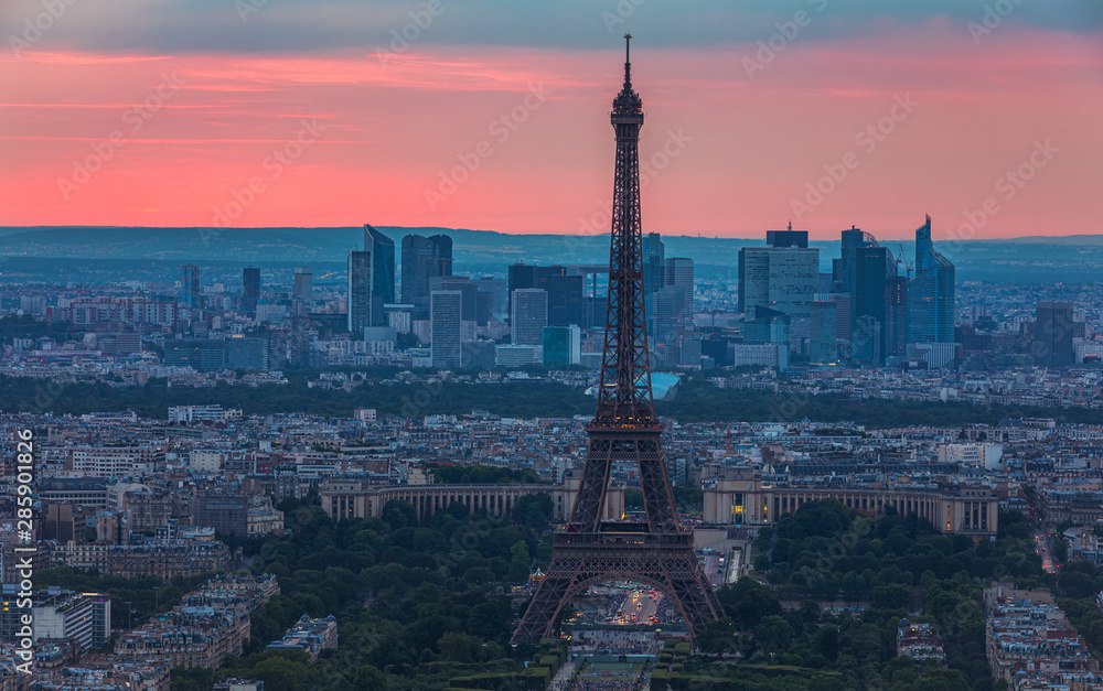 View of Paris with Eiffel Tower from Montparnasse building. Eiffel tower view from Montparnasse at sunset, view of the Eiffel Tower and La Defense district in Paris, France.