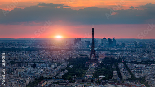 View of Paris with Eiffel Tower from Montparnasse building. Eiffel tower view from Montparnasse at sunset, view of the Eiffel Tower and La Defense district in Paris, France. © daliu