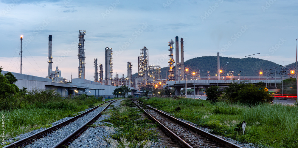 industrial oil and gas production plant with the foreground railroad at evening