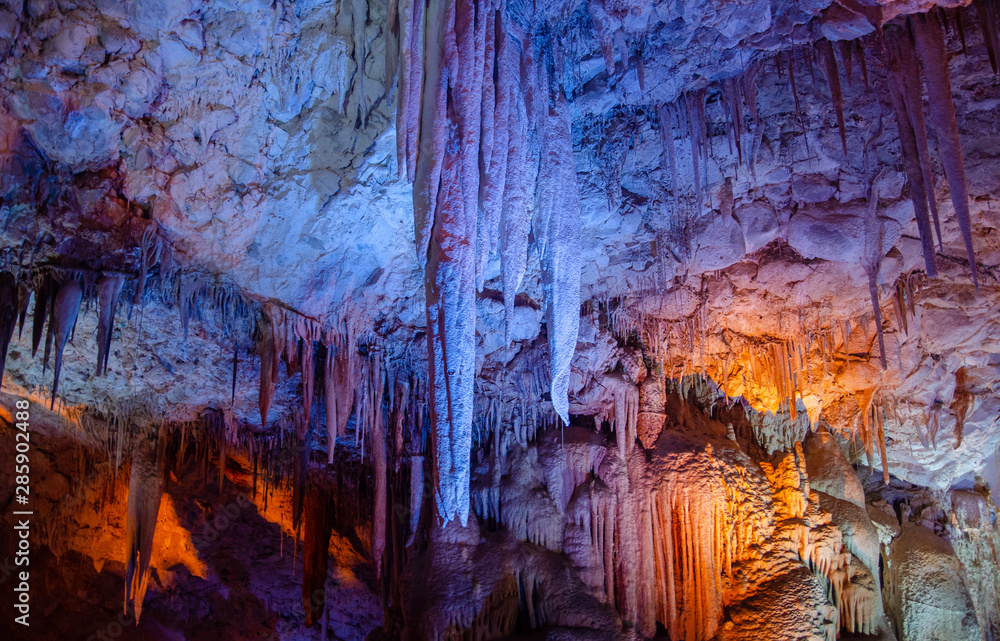 Colorful illuminated stalactites at Stalactites Cave also known as Soreq Cave and Avshalom Cave