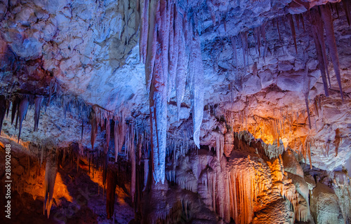 Colorful illuminated stalactites at Stalactites Cave also known as Soreq Cave and Avshalom Cave