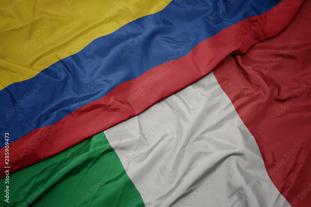 waving colorful flag of italy and national flag of colombia. waving colorful flag of italy and national flag of colombia.