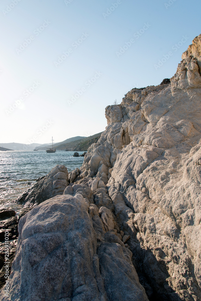 A view of a rocky beach with no people in Patmos, Greece A view of a rocky beach with no people in Patmos, Greece