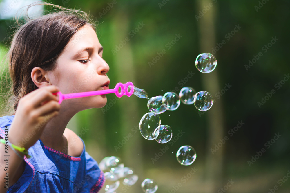 happy beautiful girl blowing soap bubbles outdoor happy beautiful girl blowing soap bubbles outdoor