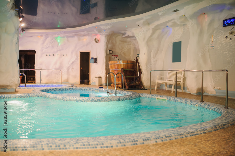 the interior of the aquazone in a spa salon: swimming pool and a janapese tube