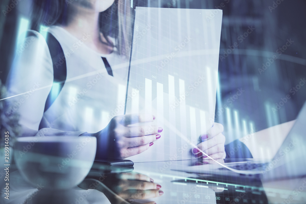 Double exposure of hands making notes with forex chart huds. Stock market concept. Double exposure of hands making notes with forex chart huds. Stock market concept.