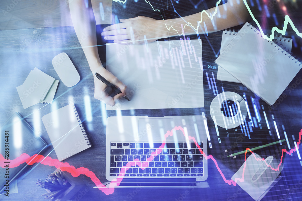 Financial graph displayed on woman's hand taking notes background. Concept of research. Multi exposure Financial graph displayed on woman's hand taking notes background. Concept of research. Multi exposure