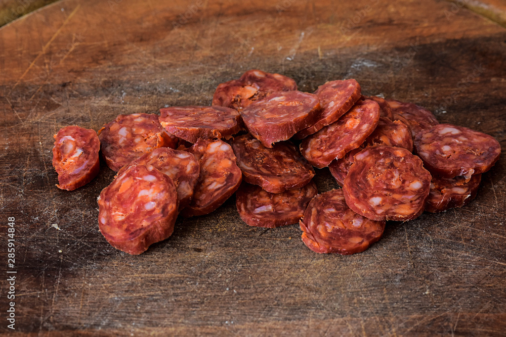 Sliced Raw Sausage Salami on Wooden Cutting Board Ready to Eat/ Closeup still life food photography Sliced Raw Sausage Salami on Wooden Cutting Board Ready to Eat/ Closeup still life food photography