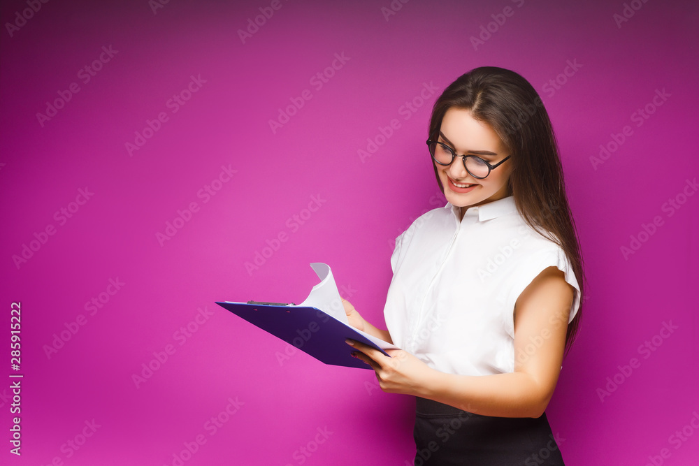 Portrait of smiling business woman with paper folder, isolated on violet background. Portrait of smiling business woman with paper folder, isolated on violet background.