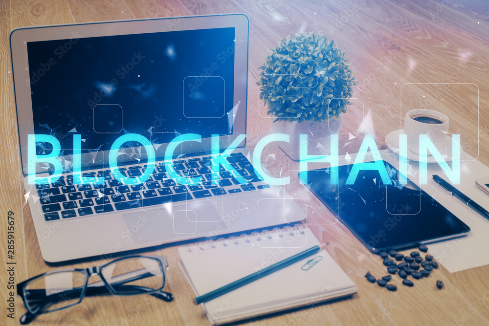 Double exposure of blockchain and crypto economy theme hologram and table with computer background. Concept of bitcoin cryptocurrency. Double exposure of blockchain and crypto economy theme hologram and table with computer background. Concept of bitcoin cryptocurrency.