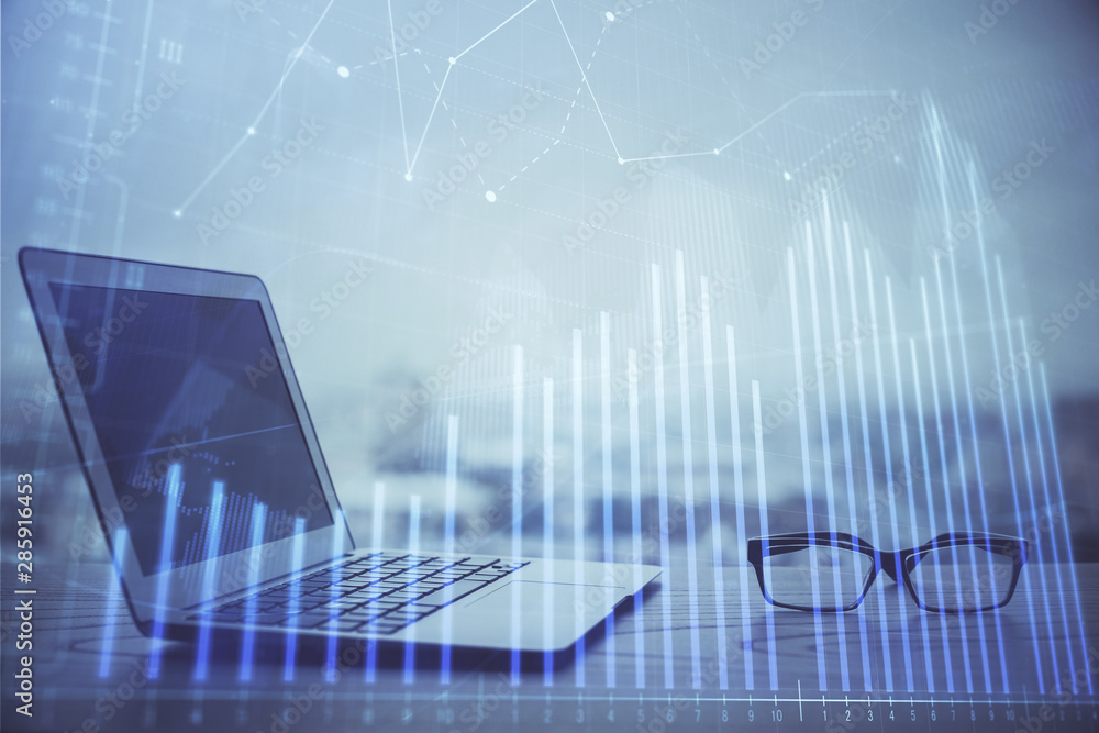 Forex graph hologram on table with computer background. Multi exposure. Concept of financial markets. Forex graph hologram on table with computer background. Multi exposure. Concept of financial markets.