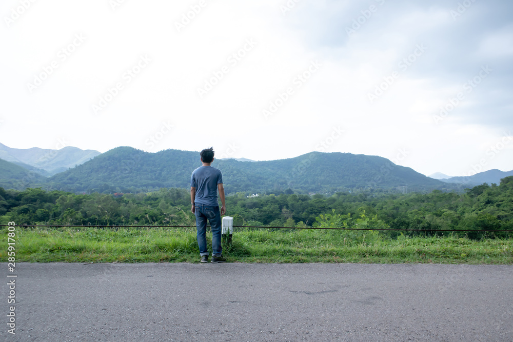 A man stood looking at the mountains and the sky while the wind was strong. , Evening time and the rain is coming. A man stood looking at the mountains and the sky while the wind was strong. , Evening time and the rain is coming.