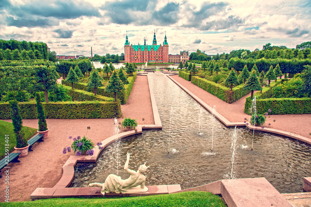 beautiful landscape with fountain and magical incredible gardens and park Frederiksborg slot Castle near Copenhagen. Hillerod, Denmark. Exotic amazing places. Popular tourist atraction.