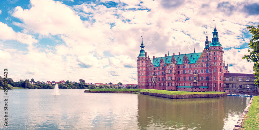 Obraz premium beautiful landscape with largest Renaissance castle in Scandinavia Frederiksborg slot Castle near Copenhagen. Hillerod, Denmark. Exotic amazing places. Popular tourist atraction.
