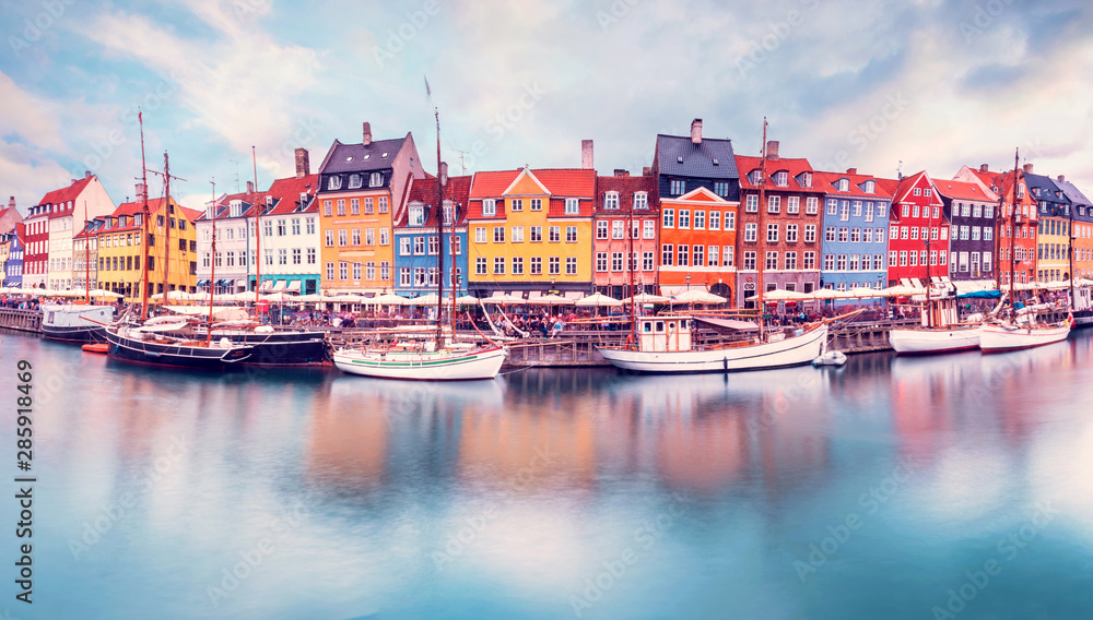 Unmatched magical fascinating landscape with boats in a famous Nyhavn in the capital of Denmark Copenhagen. Exotic amazing places. Popular tourist atraction. - obrazy, fototapety, plakaty 