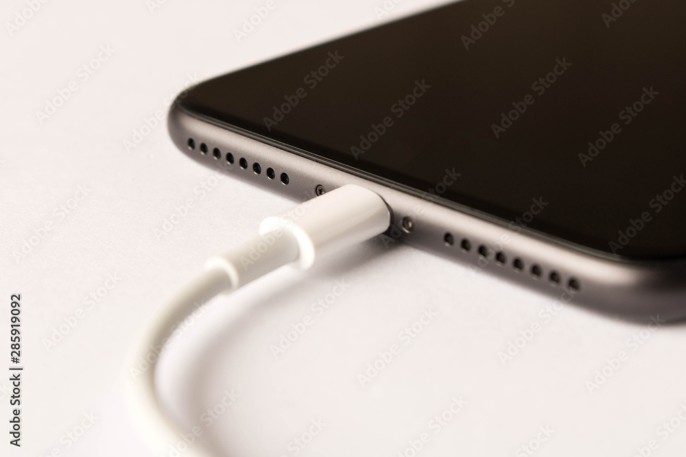 Smartphone on charge . On white background. Close up. Smartphone on charge . On white background. Close up.