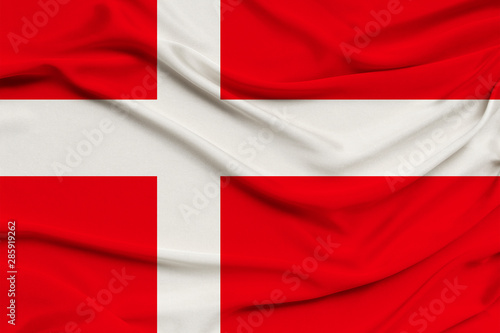 Denmark flag on silk fabric background with waves and drapery. Background for design, close-up, copy space