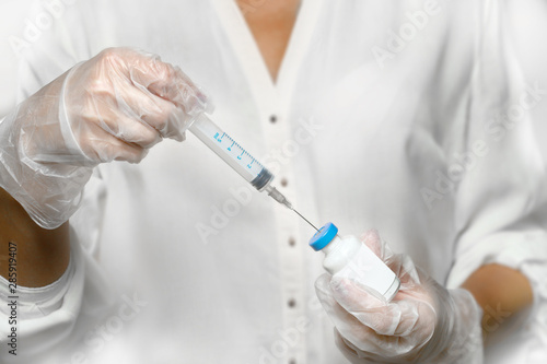 doctor with syringe in hand take a Vaccine with bottle and blanked log 