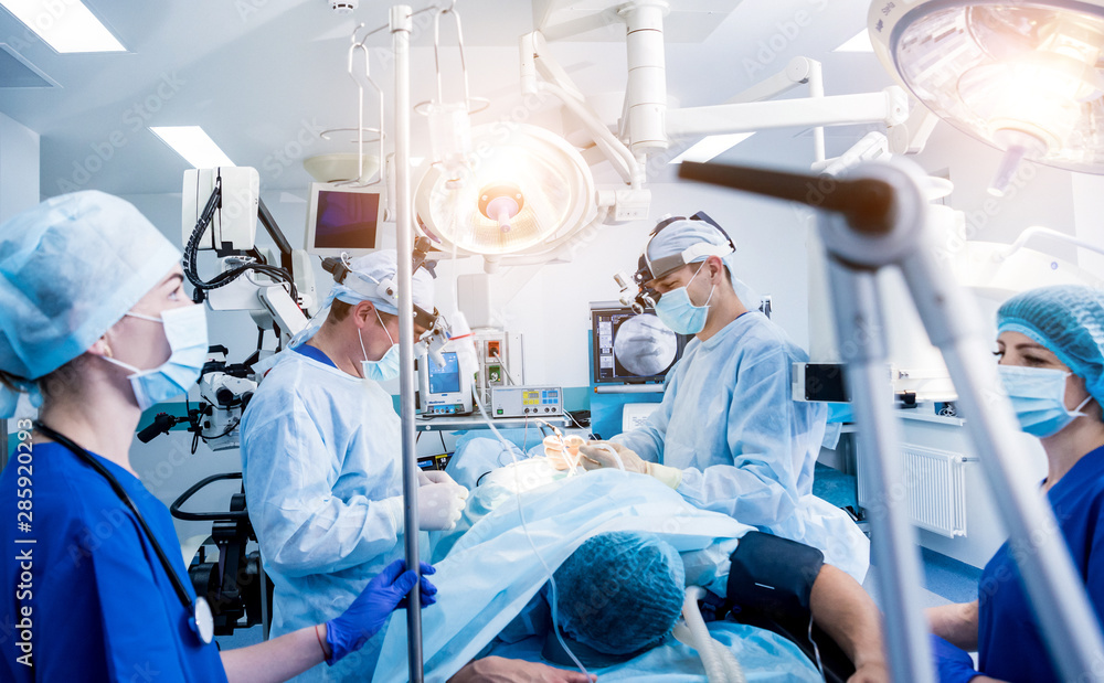 Spinal surgery. Group of surgeons in operating room with surgery equipment. Laminectomy Spinal surgery. Group of surgeons in operating room with surgery equipment. Laminectomy